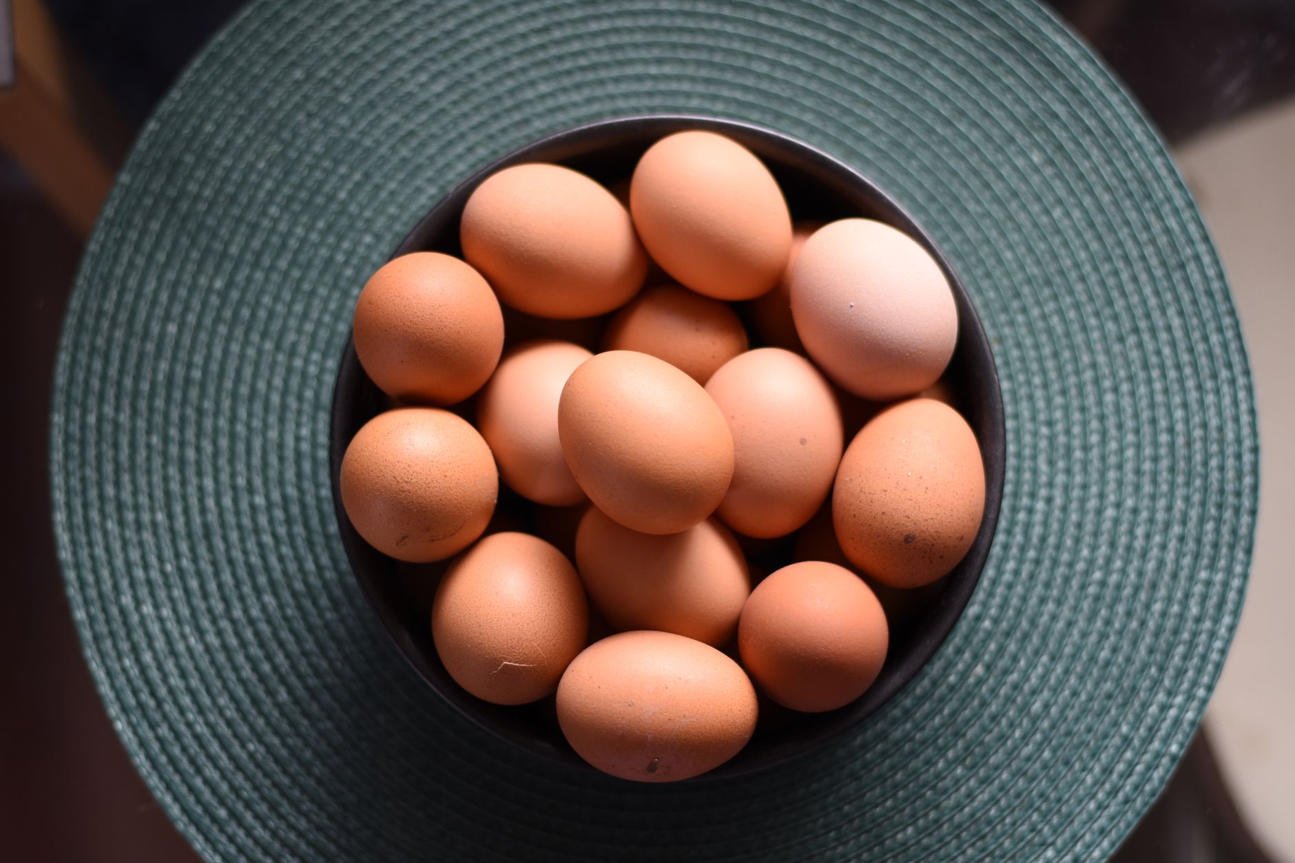 overhead shot of a bowl with brown eggs