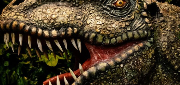 close up of realistic dinosaur head in jungle
